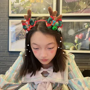 Christmas reindeer antler headband with cute bows and bells, festive hair accessory for women.