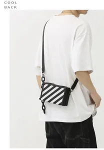 Sac bandoulière boîte de mode unisexe avec rayures noir et blanc et chaîne tendance.