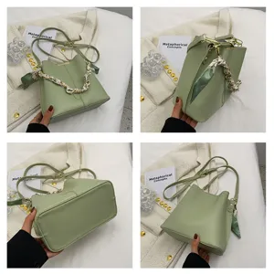 Detailansicht der hellgrünen Damen Leder Beuteltasche mit Kette und schickem Schal.