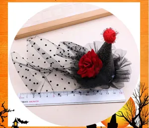 Halloween witch hat hair accessory detail shot with black mesh, rose and pom-pom.