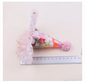 Cute rainbow tulle birthday hat party hair accessory decorated with colorful pom poms inside.