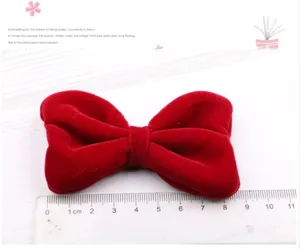 Red velvet bow hair clip for women and girls, elegant side bangs clip and hair styling accessory.