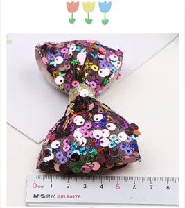 Colorful sequin bow hair clip detail, sparkly hair accessory for girls party and performance.