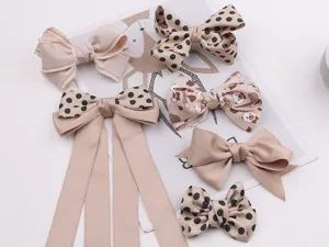 Detailed view of cute handmade children hair bows, sweet bowknot hair accessories set.