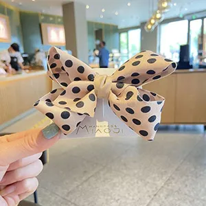 Caramel polka dot bow hair clip toddler cute handmade fabric hair accessory detail view