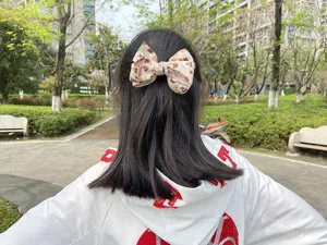 Kids handmade caramel hair bow clip with cute bear print ribbon, perfect daily hair accessory.