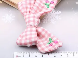 Pink gingham bow hair clip with cute embroidered cherries, perfect for sweet daily hairstyles.