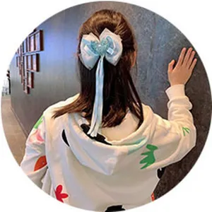 Cute kids mesh hair bow with long ribbons and heart detail, perfect hair clip for girls.