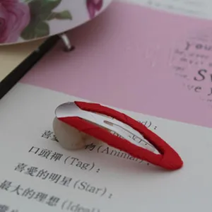 Red grosgrain ribbon wrapped BB hair clip detail view, cute hair accessory for kids.