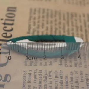 Green ribbon wrapped hair clip detail view, DIY hair accessories for kids hair styling.
