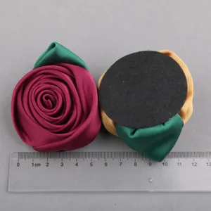 Close-up detail shot of handmade fabric flower DIY accessories with clear size reference.
