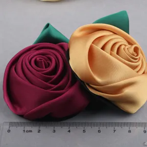 Handcrafted fabric rose flower patches, DIY hair accessories and brooch clothing decor details.