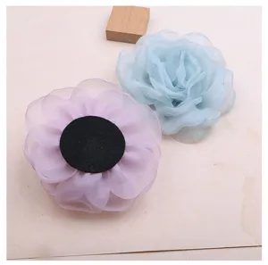 Chiffon camellia flower detail shot, showcasing handmade organza texture and vibrant floral craft.