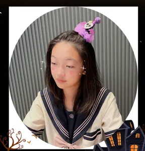 Kids Halloween mini hat hair clip with purple tulle and skull decor, cute festival party hair accessory.