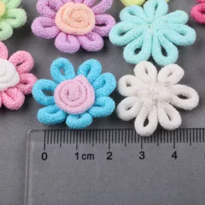 Handmade fabric flower craft details close up view for DIY accessories and clothing decoration