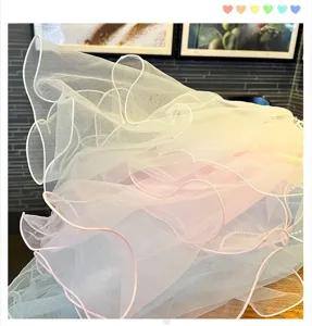 Detailed shot of colorful layered tulle mesh fabric, pastel gradient veil material for crafts.