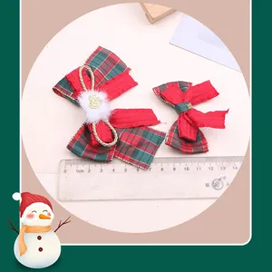 Christmas red green plaid bow hair clip detail view, festive hair accessory decoration.
