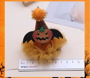 Halloween pumpkin hair clip close-up, featuring cute bat wings, tutu mesh, and sparkly pompom details.