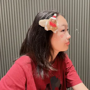 Cute Christmas gingerbread plush hair clip for girls, soft winter side hair accessory.