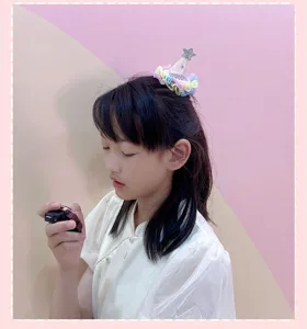 Cute kids mini party hat hair clip with colorful ruffles and star for girls daily wear.