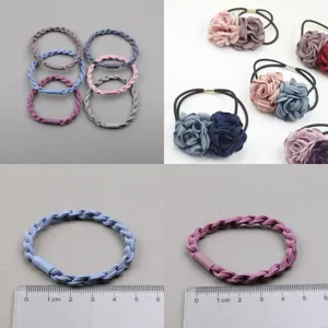 Detail shot of braided hair ties and fabric flower hair bands, showing size and texture.