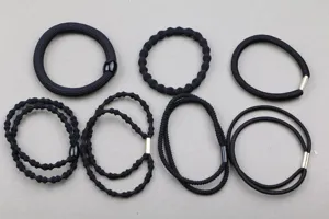 Detailed view of assorted black hair ties and elastic bands for daily styling and DIY projects.
