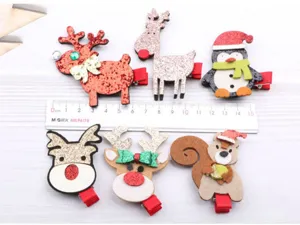 Nahaufnahme von niedlichen weihnachtlichen Haarspangen mit Rentier und Pinguin Motiven.
