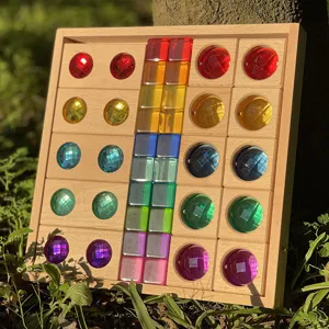 Outdoor detail shot of colorful acrylic light-transmitting blocks in wooden sorting tray.