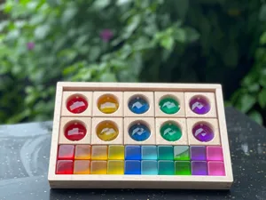 Acrylic translucent crystal block set, colorful geometric puzzle toy details, wooden tray.