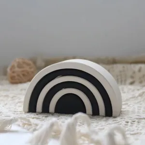 Dettaglio giocattolo impilabile arcobaleno bianco e nero minimalista, ideale per bambini.