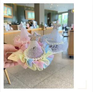 Close-up detail of children tulle crown hair clip with pearls and star decor, cute party style.