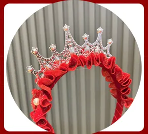 Red crown hairband detail shot featuring silver tiara frame and festive ruffled fabric style.
