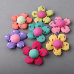 Detailed view of colorful fabric flowers, DIY craft accessories and clothing decors.