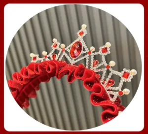 Kids red crown headband detail, sparkling rhinestones and pearls with festive pleated fabric.