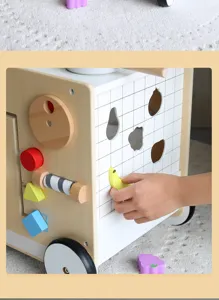 Wooden baby activity walker detail view, shape sorting and fruit matching toy parts close-up.