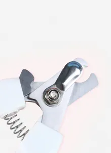 Detailed view of stainless steel pet nail clipper with safety guard and spring mechanism.