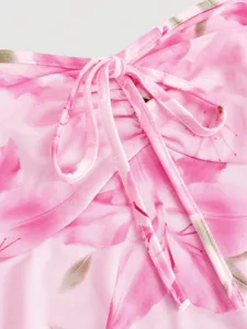 Pink floral dress detail shot featuring elegant drawstring ruching and soft breathable fabric texture.