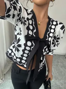 French style black and white floral short sleeve blouse with front bow tie and lantern sleeves.