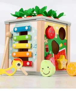 Detailed view of wooden baby activity cube, featuring shape matching blocks and colorful xylophone.
