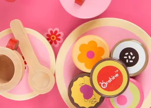 Wooden toy afternoon tea pastry set detail view showing colorful cookies, plate and spoon.