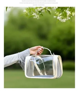 Breathable transparent pet bird carrier bag with mesh sides for outdoor travel convenience.