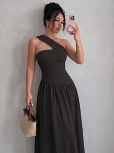 Detailed view of a dark one shoulder sleeveless pleated dress with a-line waist silhouette.