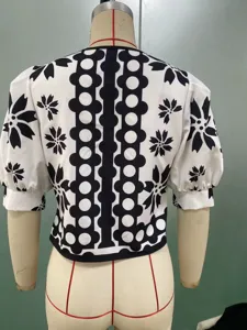 Chic black and white graphic print short sleeve blouse with elegant puff sleeves.