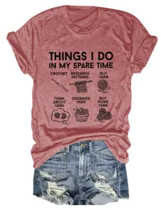 Close-up detail of the funny printed quote and graphic icons on the red casual t-shirt fabric.
