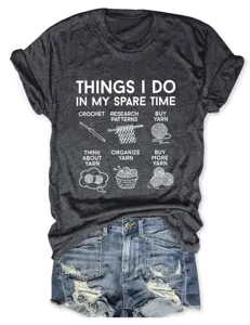 Detail view of dark grey graphic t-shirt featuring fun yarn hobby print and denim shorts.