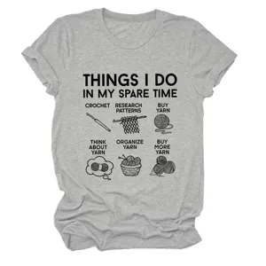 Detailed view of grey short sleeve t-shirt featuring funny crochet and yarn print design.