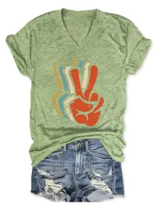 Green V-neck short sleeve T-shirt featuring a retro peace sign graphic and denim shorts detail.