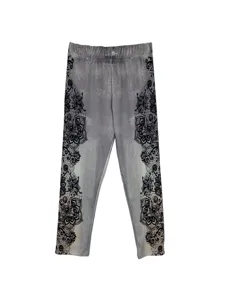 Detail view of women printed denim leggings with elegant black floral lace side patterns.