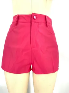 Close-up detail of hot pink high waist PU leather shorts with button and zipper closure.