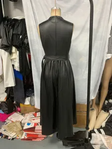 Detail shot of black faux leather sleeveless maxi dress, round neck with waist belt.